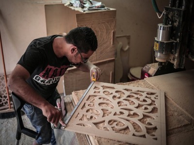 Mahmoud in his carpentry workshop, building furniture